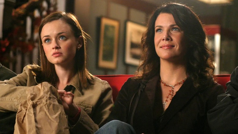 Rory and Lorelai sitting on a couch in the movie theater