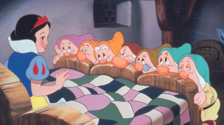 Snow White meets the dwarfs in Snow White and the Seven Dwards