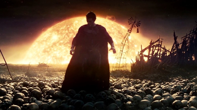Henry Cavill as Superman in "Man of Steel," standing atop skulls
