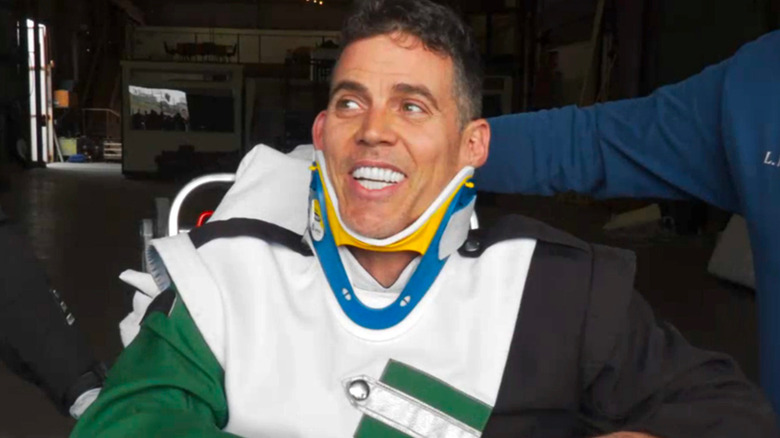 Steve-O smiling in a neck brace