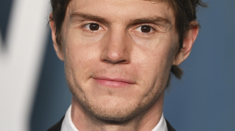 Evan Peters smirking for the press