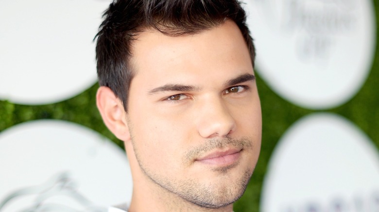 Taylor Lautner smiling at event