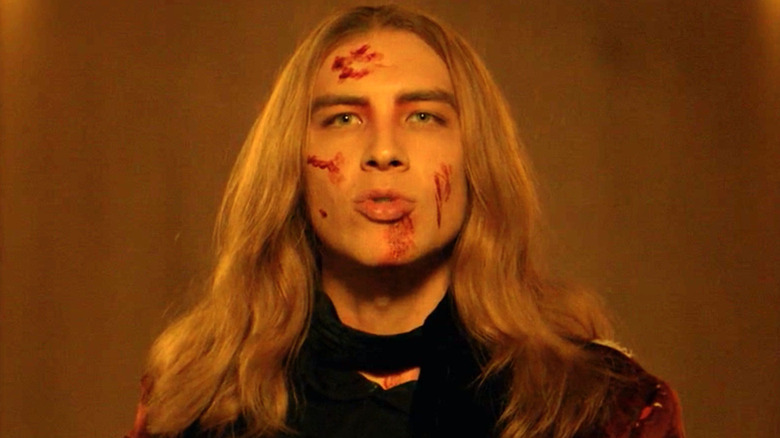 Cody Fern as Michael Langdon, blood on face, in AHS Apocalypse