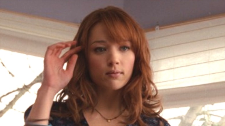 Kristen Connolly touches hair