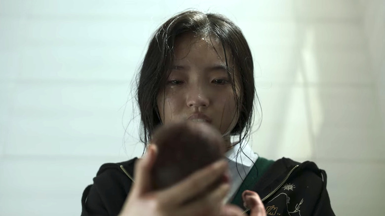 Park Hee-su holding her baby