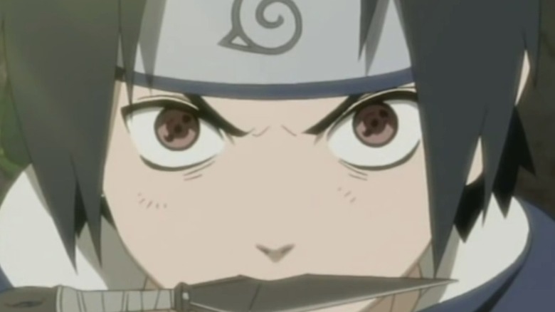 Sasuke holding a kunai in his mouth