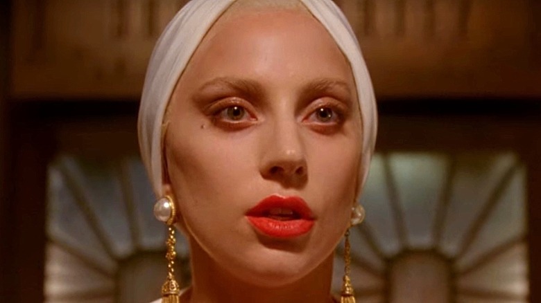 Lady Gaga bold lipstick and pearl earrings