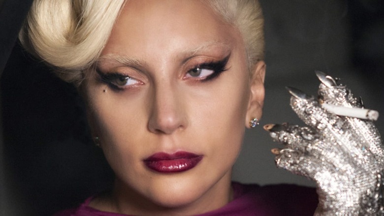 Lady Gaga holding cigarette in rhinestoned glove