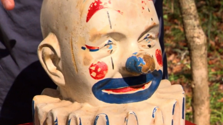 Scary clown statue smiling creepily