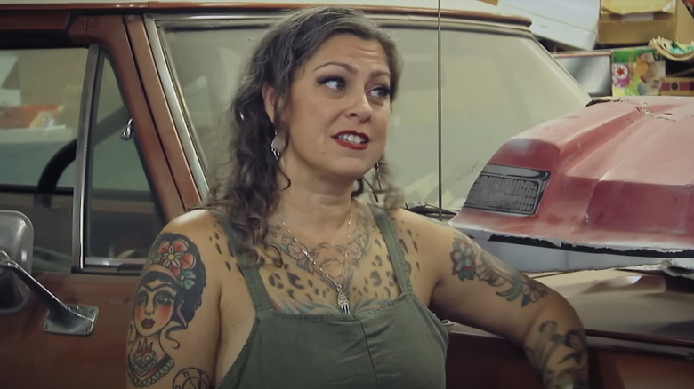 Danielle Colby leaning on a Dodge Ramcharger