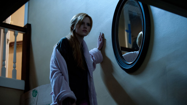 Amityville girl next to mirror