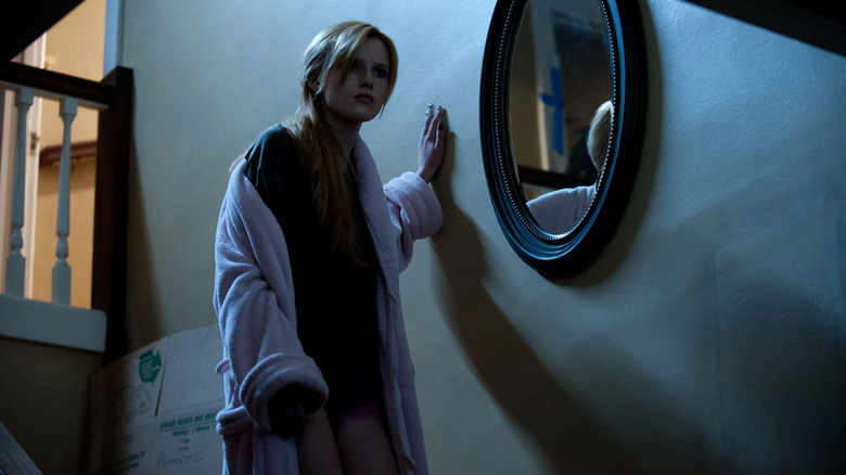 Amityville girl next to mirror