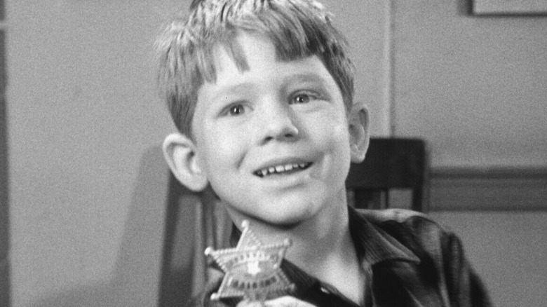 Opie holding badge