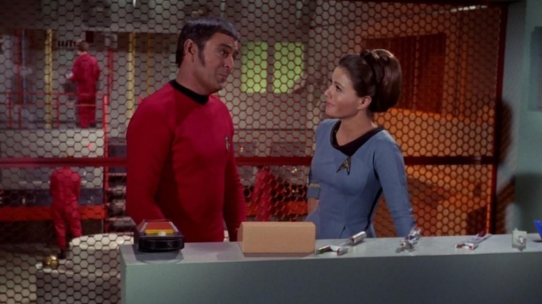 Montgomery "Scotty" Scott and Mira Romaine looking at each other