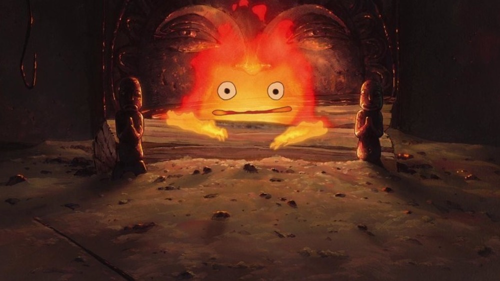 Calcifer hunched over wooden log