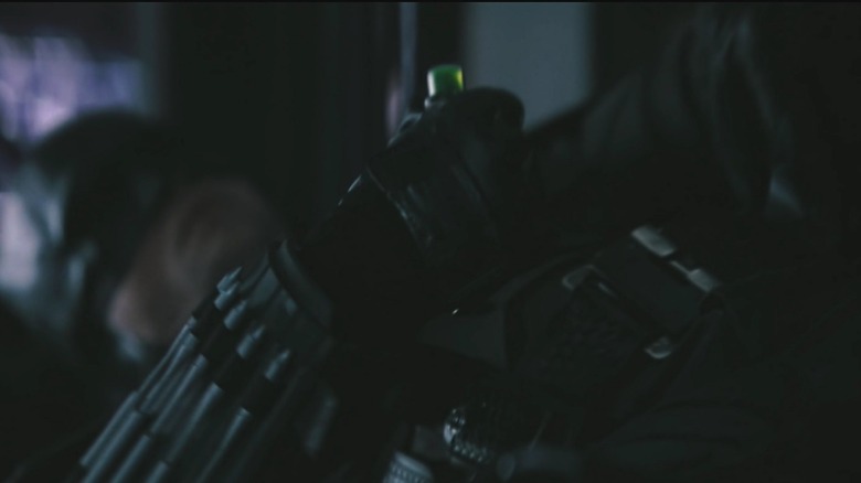 Batman holding a green vial in "The Batman"