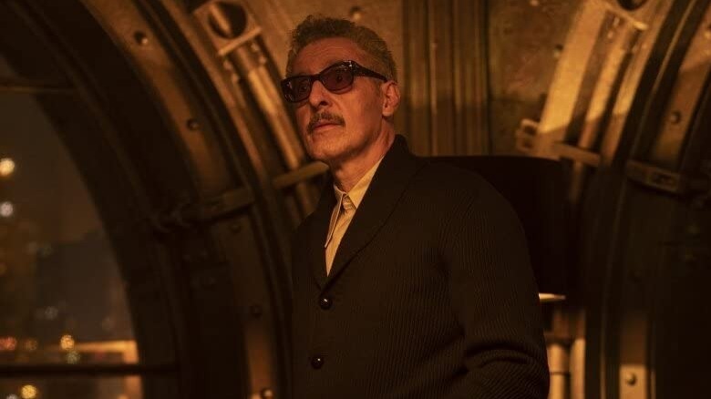 Carmine Falcone wearing glasses