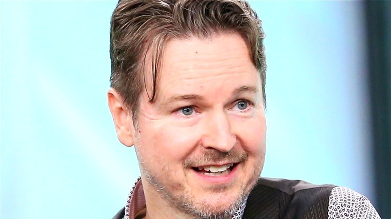 Matt Reeves smiling in gray shirt