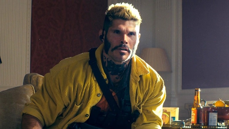 Lazarus sitting down in "The Beekeeper" (2024)