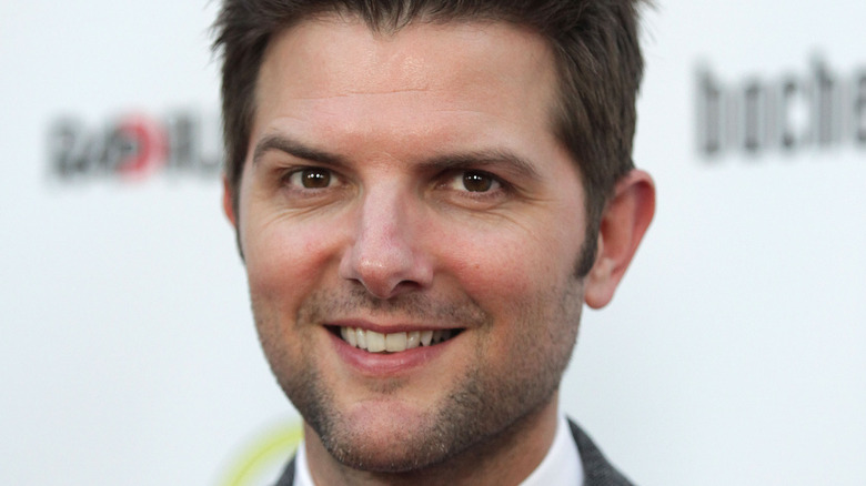 Adam Scott smiling and cocking eyebrow