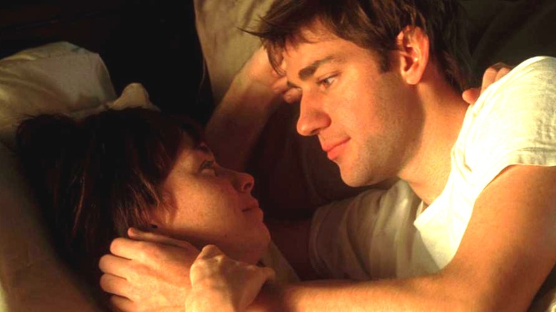 Ryan and Sara Quinn in bed, looking into each other's eyes