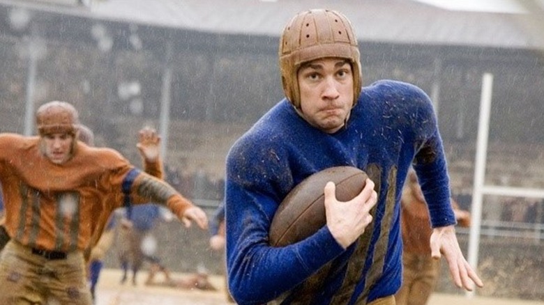 Carter Rutherford in a 1920s football uniform running downfield
