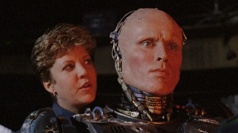 RoboCop aiming a gun with Anne Lewis