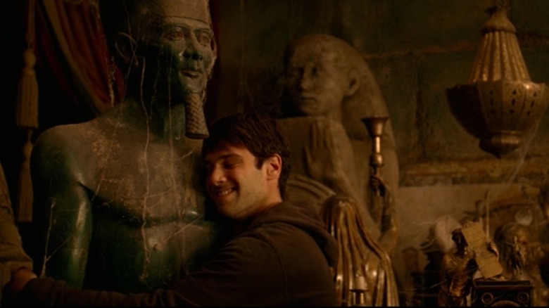 Ben hugging an ancient artifact