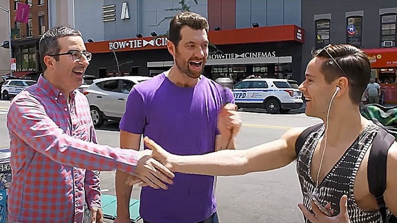Billy Eichner with John Oliver shaking hands with young man