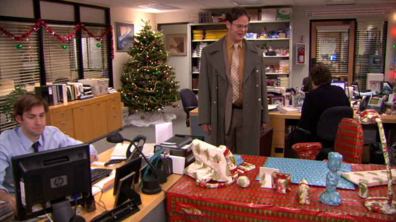 Dwight looking at gift-wrapped desk