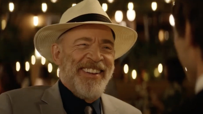 A close-up of Roy (J.K. Simmons) laughing with glee in conversation with Nyles (Andy Samberg)