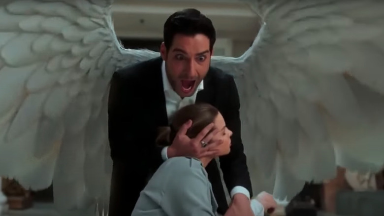 Lucifer uses his wings to shield Chloe