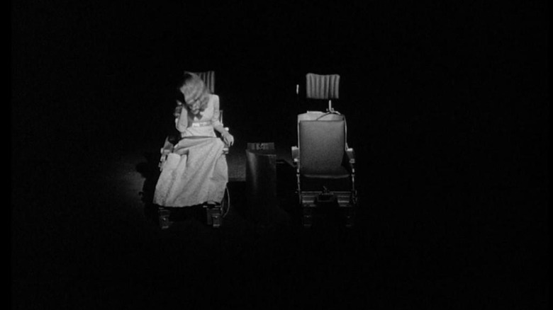 Woman in a chair in the dark
