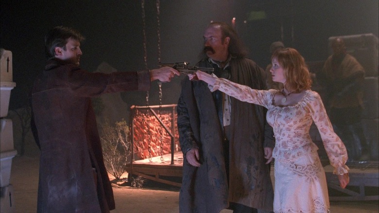 Malcolm Reynolds and Saffron pointing guns