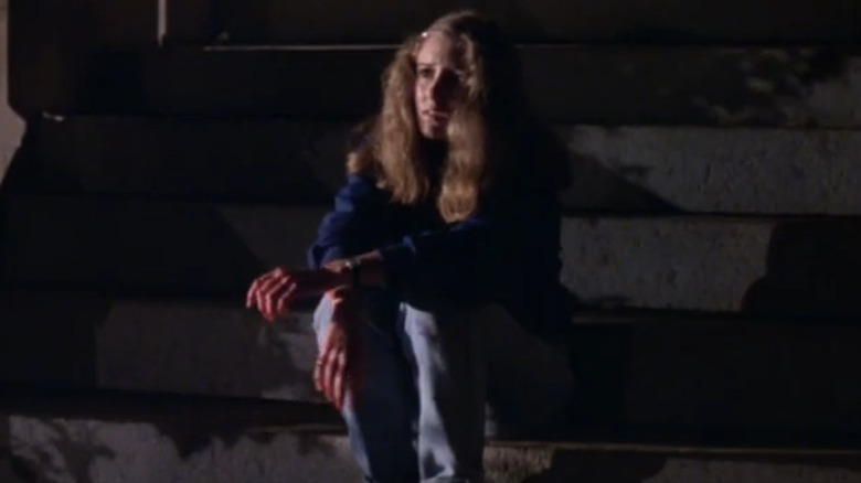 Courtney sits on steps