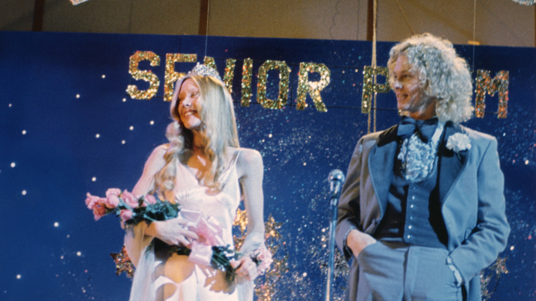 Carrie accepting prom queen crown and flowers