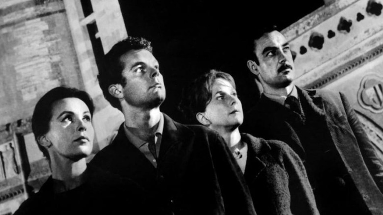 The cast looks up at the house