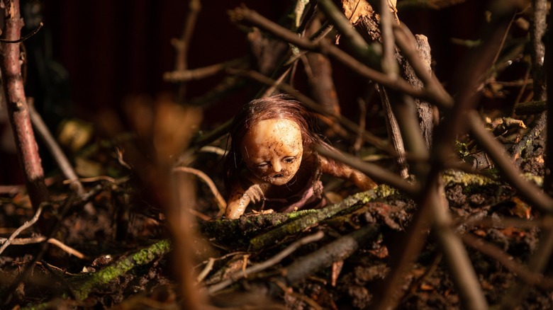 Stop-motion puppet crawls in twigs