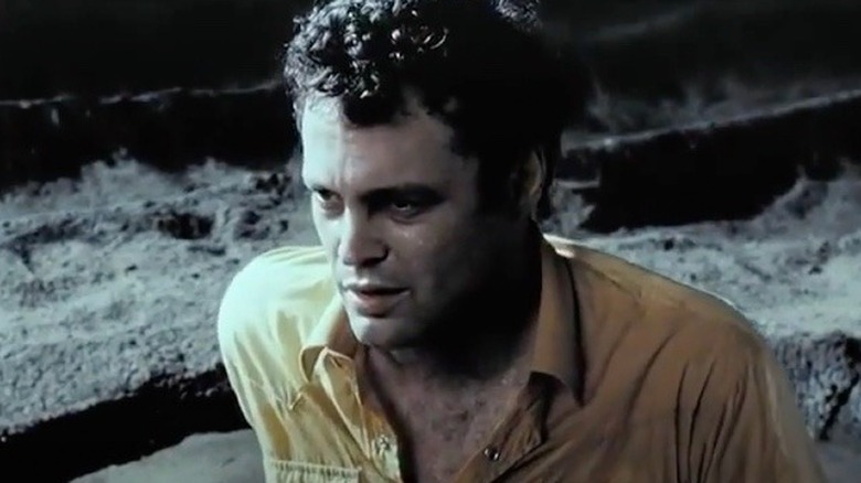 Peter Novak sitting on beach