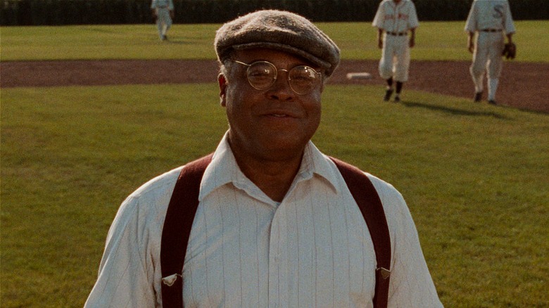 Terence Mann standing in baseball field smiling about to speak