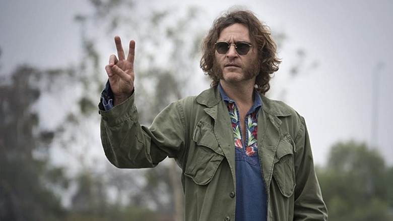 Joaquin Phoenix giving peace sign