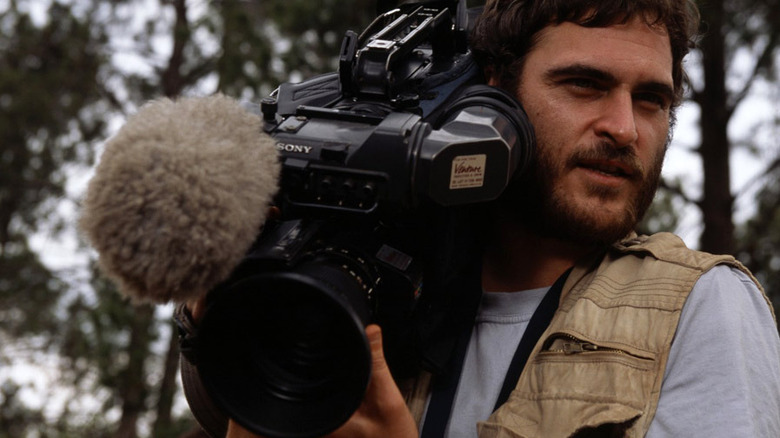 Joaquin Phoenix holding camera