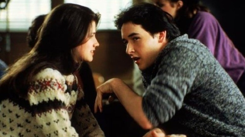 John Cusack talking to Daphne Zuniga