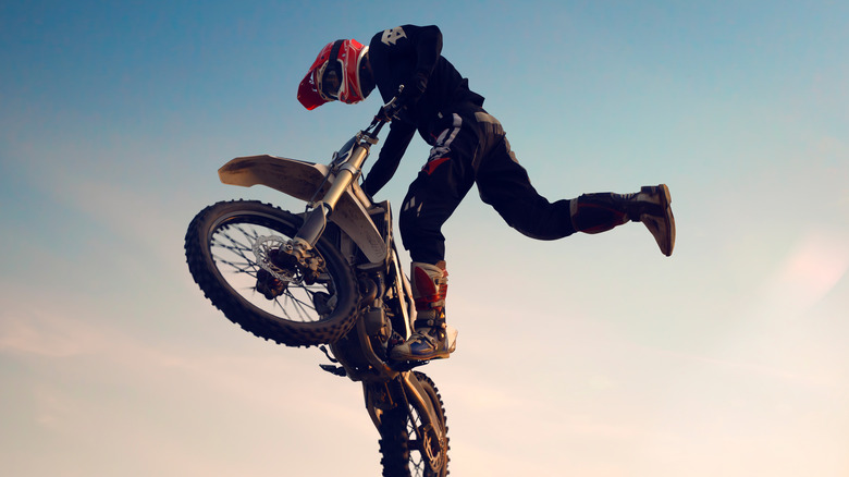 A dirbike rider performs a jump