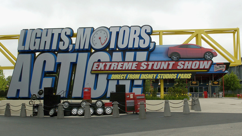 Lights, Motors, Action! sign on display in an open paved area