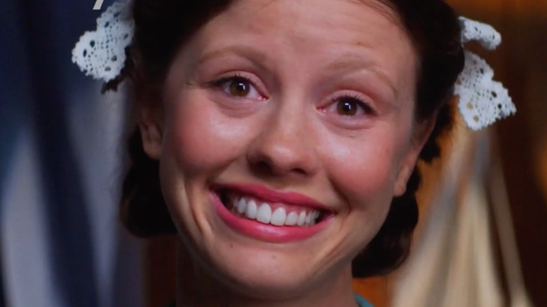 Mia Goth smiles wide