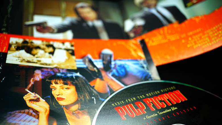 Tarantino next to a Pulp Fiction poster