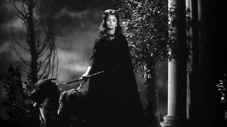 Woman holding two dogs