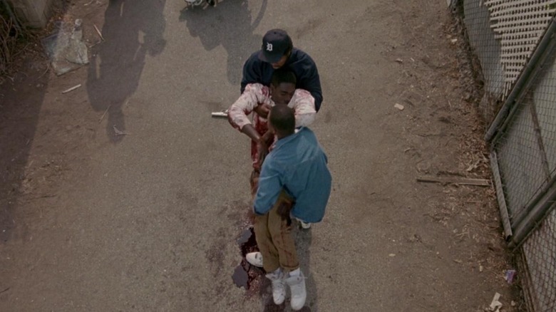 Doughboy (Ice Cube) and Tre (Cuba Gooding Jr.) catching Ricky (Morris Chestnut) before he falls as a result of his gun wounds