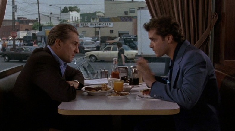 Henry (Ray Liotta) conferring with his close friend and business associate Jimmy (Robert de Niro) over breakfast at a diner